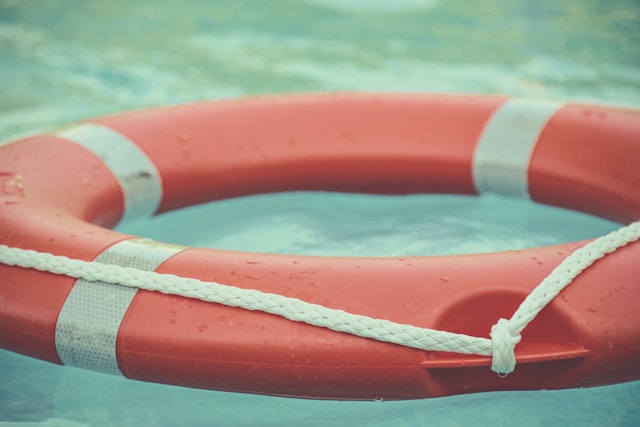 orangeroter Rettungsring auf türkisfarbenem Wasser